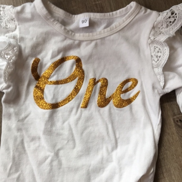 Baby girl onesie shirt with gold lettering spells “one” frill detail on sleeve - Picture 2 of 2
